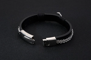 Detail of men's leather bracelet with stainless steel clasp and side chain layers