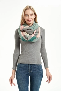 Close-up of a warm knit infinity scarf for women featuring pastel color block patterns