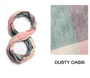Macro texture of a checkered knit scarf featuring pink and green patchwork patterns