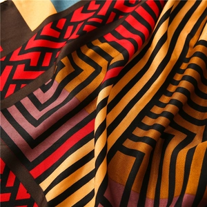 Macro shot of colorful geometric pattern scarf with silk texture and zig-zag stripes