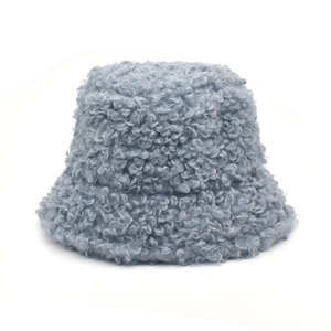 Close-up of thick light blue plush lamb wool texture on a winter bucket hat for women