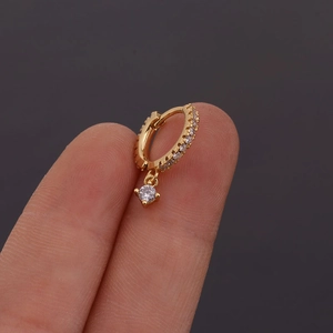 Golden round hinged hoop earring featuring a delicate sparkling diamond pendant