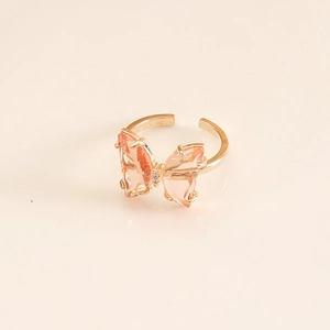 Macro shot of pink butterfly crystal ring with golden frame and adjustable open band