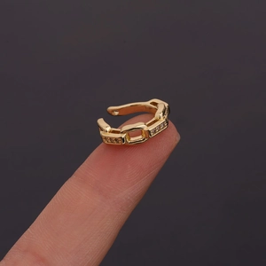 Detailed view of a gold-plated chain-link ear cuff inlaid with sparkling cubic zirconia
