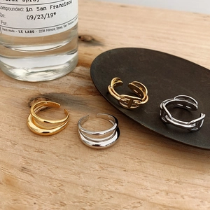 Detail of gold and silver S925 double-layer rings showing polished finish and hallmark