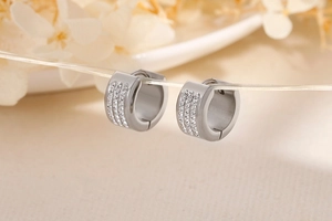 Detailed macro view of silver hoop earrings with triple row micro-pave white zircons