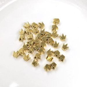 Detailed view of polished 14K gold filled crown-shaped spacer beads for DIY jewelry making