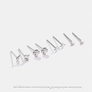 Detail of 4 pairs of s999 sterling silver stud earrings featuring star and clover shapes