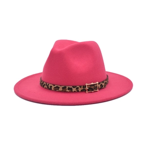 Detail of fuchsia fedora hat featuring a leopard print band and golden metal buckle