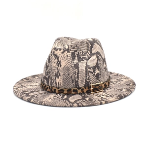 Detail of snake skin pattern fedora hat featuring a leopard print belt and metal buckle