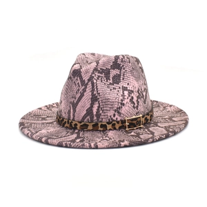 Detail of pink snakeskin fedora hat with leopard print band and gold buckle accent