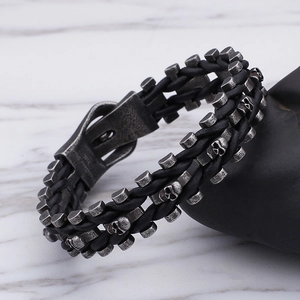 Punk style men's braided black leather bracelet featuring a silver stainless steel skull