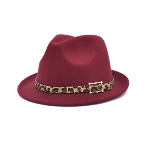 Close-up of wine red wool fedora hat with leopard print band and golden metal buckle