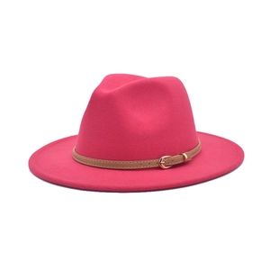 Detail of rose red wide brim fedora hat featuring light brown leather belt with gold buckle