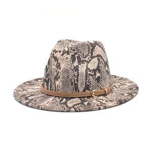Detail of snake skin pattern wide brim fedora with brown leather belt and gold buckle
