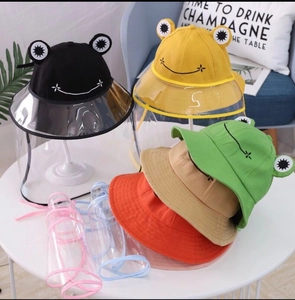 Detailed display of colorful frog-shaped kids' sun hats with clear protective masks