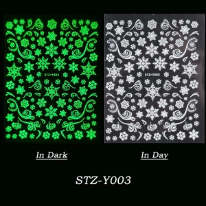 Luminous snowflake nail stickers showing white day look and green glow in dark effect