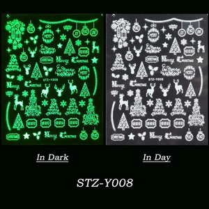 Glow in the dark Christmas nail stickers featuring reindeer and snowflake patterns