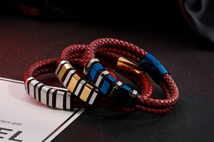 Macro detail of red woven leather bracelets with metallic geometric accents for men
