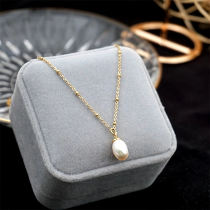 Double-layered gold-toned titanium steel necklace with a water-drop pearl pendant