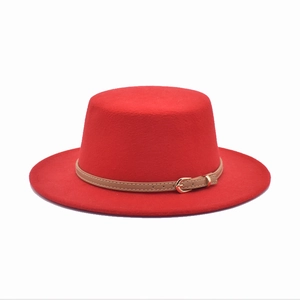 Close-up of red wool felt jazz hat with brown faux leather belt and gold metal buckle