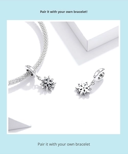 Detailed view of S925 sterling silver snowflake charm with sparkling cubic zirconia inlay
