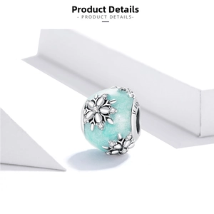 Macro shot of S925 sterling silver winter snowflake charm with mint green glitter finish