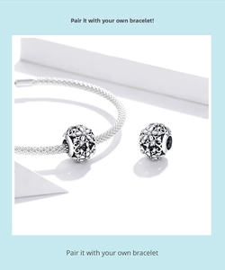 Detailed view of hollow snowflake beads with sparkling zircons on a silver mesh bracelet