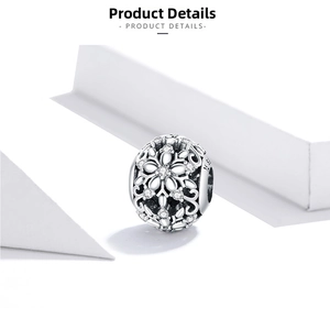 Macro detail of S925 sterling silver hollow snowflake bead with white zircon stones