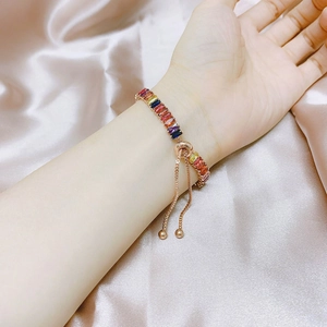 Close-up of adjustable rainbow zircon tennis bracelet with rose gold sliding bolo clasp