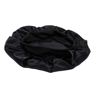 Close-up of black silk sleep cap showing smooth satin texture and elastic headband