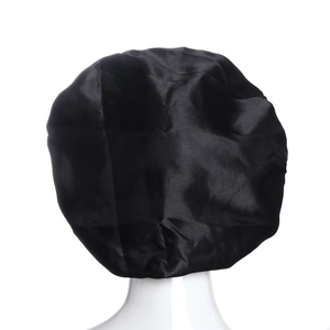 Detail showing the glossy texture and wide elastic band of a black satin sleep bonnet