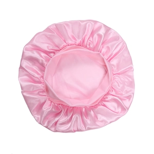 Detail of pink satin sleep cap featuring a wide elastic band and pleated edge texture