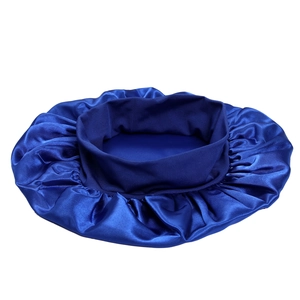 Close-up of blue satin sleep cap with wide elastic headband and pleated fabric texture
