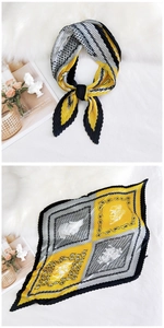 Macro view of pleated square silk scarf with yellow and grey geometric floral patterns