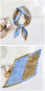 Close-up of pleated silk-like diamond scarf with elegant color block and soft texture