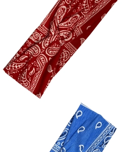 Detail view of red and blue paisley print cotton headbands with twisted knot design
