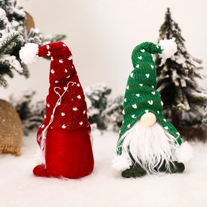 Christmas forest gnomes with knitted hats and white beards in a snowy festive forest setting