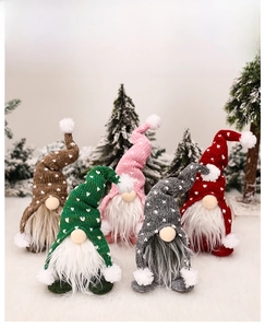 Group of five Christmas gnomes with knitted heart hats in a winter forest scene