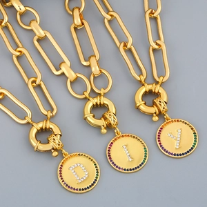 Detail of gold chain necklaces with colorful crystal-encrusted D, I, Y letter charms