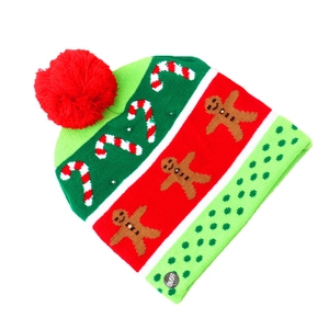 Detail of LED Christmas knit hat with ON/OFF switch label and festive patterns