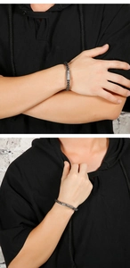 Detailed view of men's vintage grey stainless steel woven bracelet with magnetic clasp