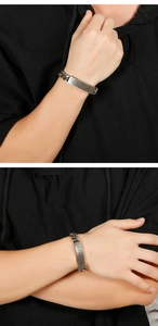 Detailed view of vintage silver Cuban chain bracelet with pray engraved metal plate