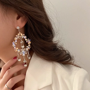 Elegant water drop tassel earrings with silver finish and colorful rhinestones on model