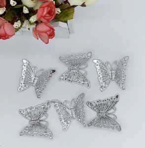 Detailed view of silver hollowed butterfly decorations for Christmas trees and DIY crafts