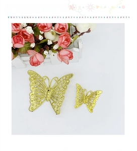Detailed view of hollow gold-plated metal butterfly ornaments for decorative crafts