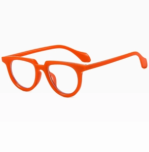 Close-up of bright orange small frame cat-eye sunglasses with transparent lenses