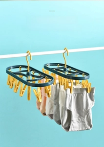 Blue plastic drying rack with 12 yellow clips for hanging underwear and socks on a rail