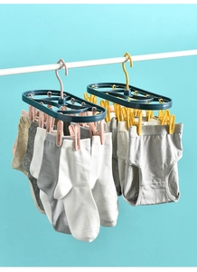Detail of multi-clip laundry drying rack with 12 clips for socks and underwear