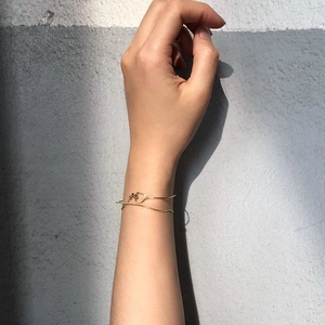 Close-up of minimalist gold plated silver snake chain bracelet on a person wrist